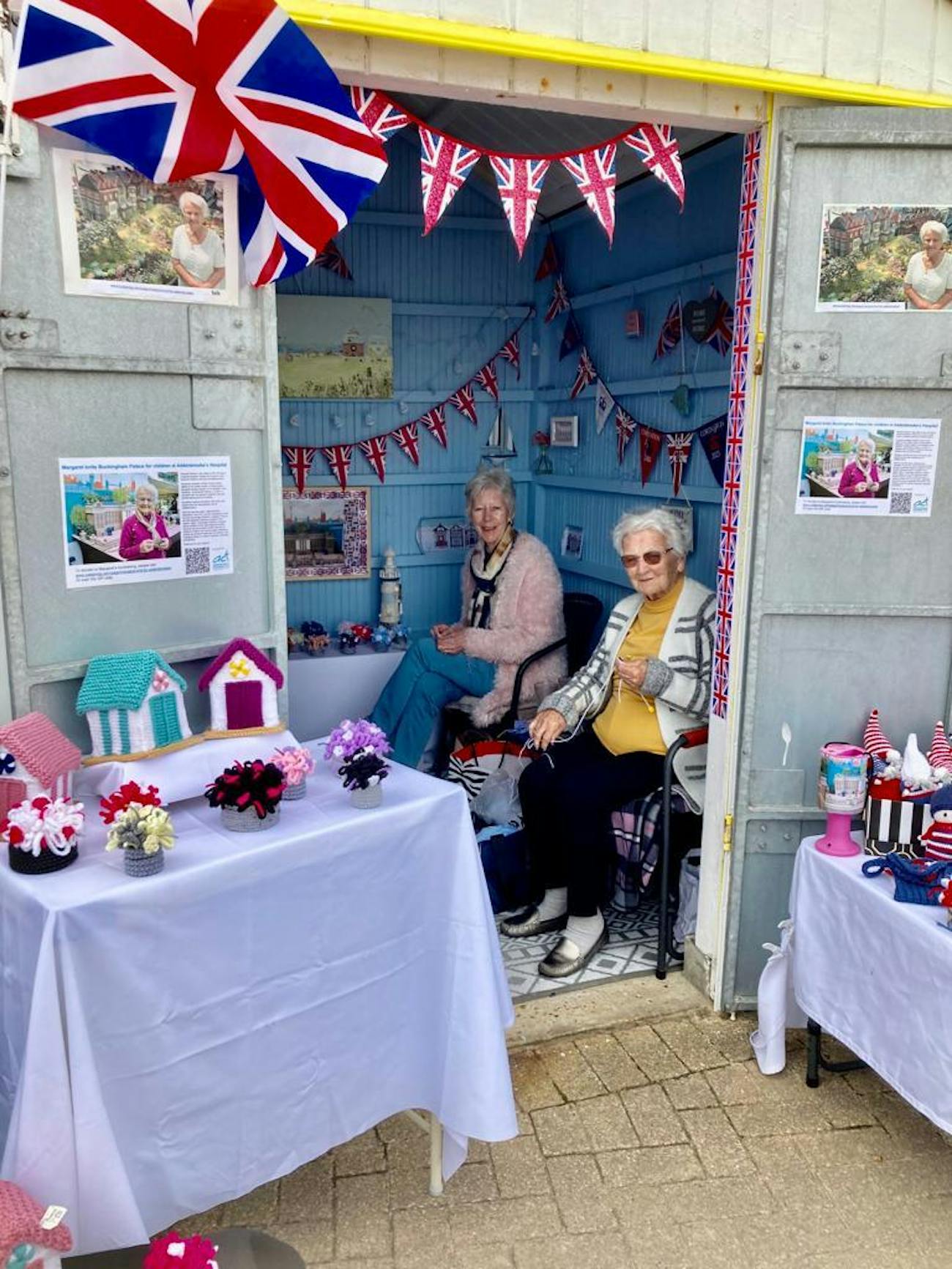 Waving the flag at their Yarmouth beach hut.